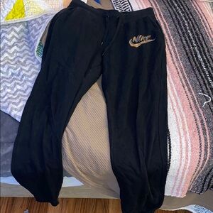 Nike Black Joggers with Gold Emblem